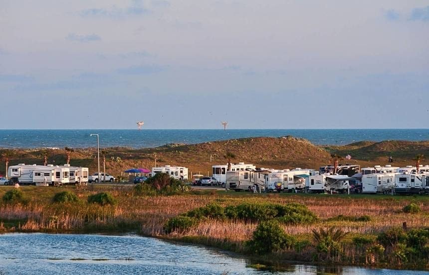 RV sites with the Gulf and dunes behind them